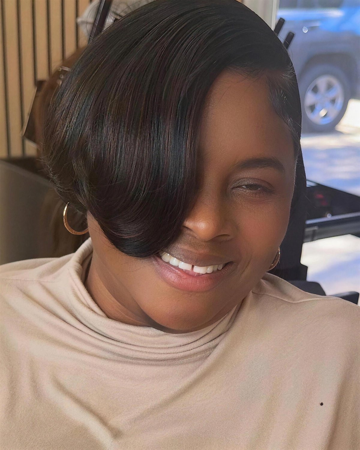 Sleek side-swept bob, glossy and smooth.